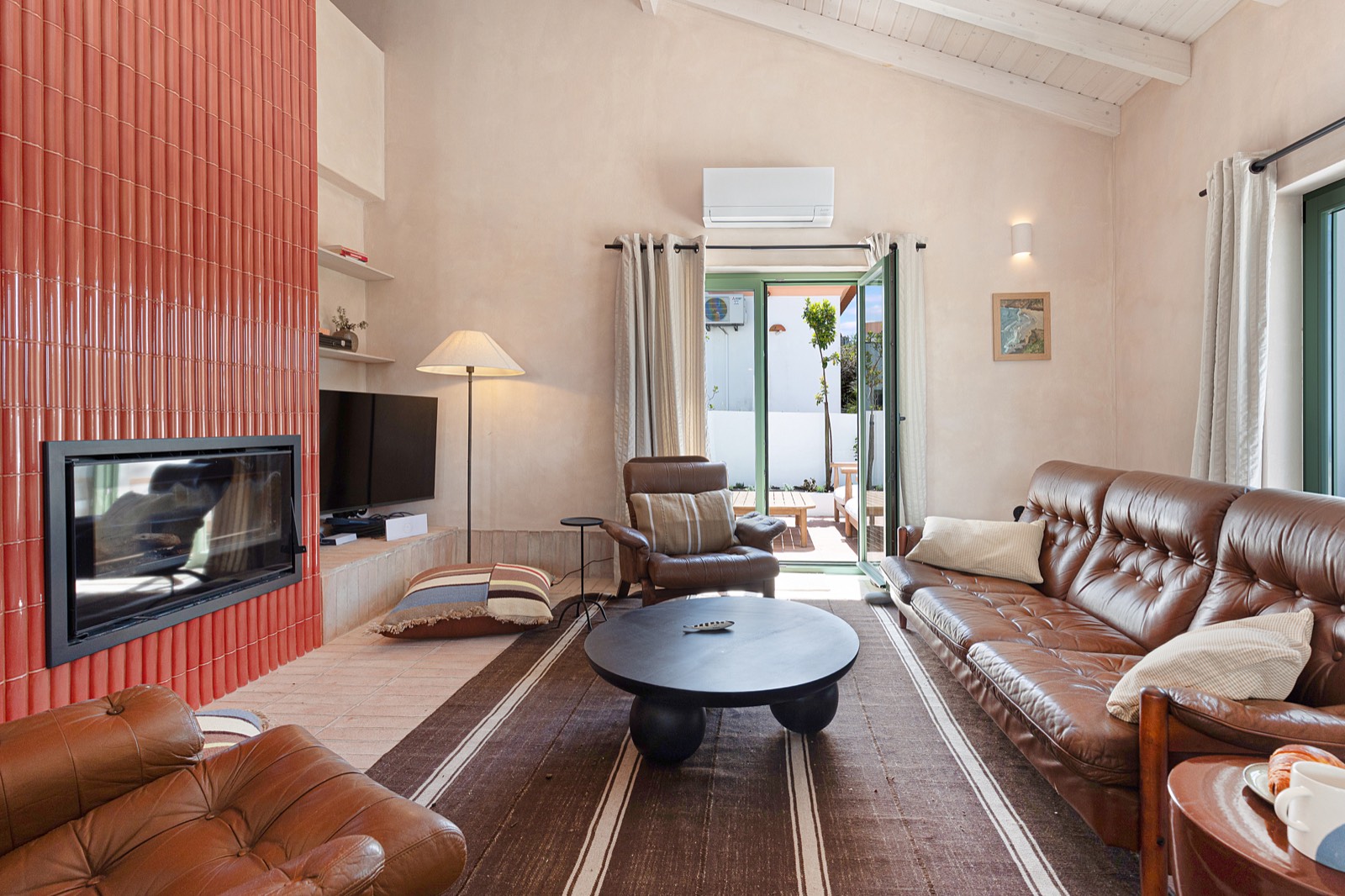 Living room with a terracotta-tiled fireplace